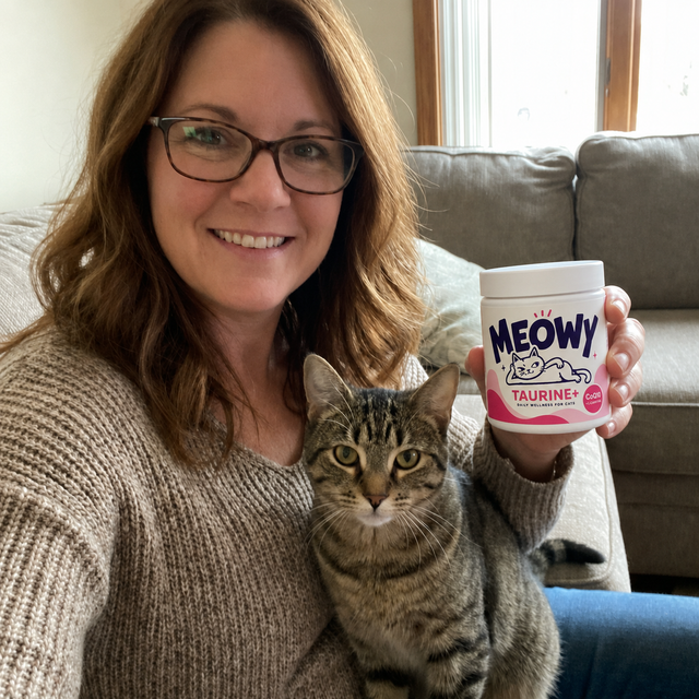 Customer photo — cat parent with her cat and Meowy Taurine+